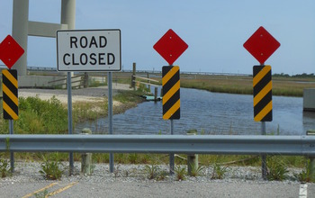 Closed highway that abruptly ends in open water.